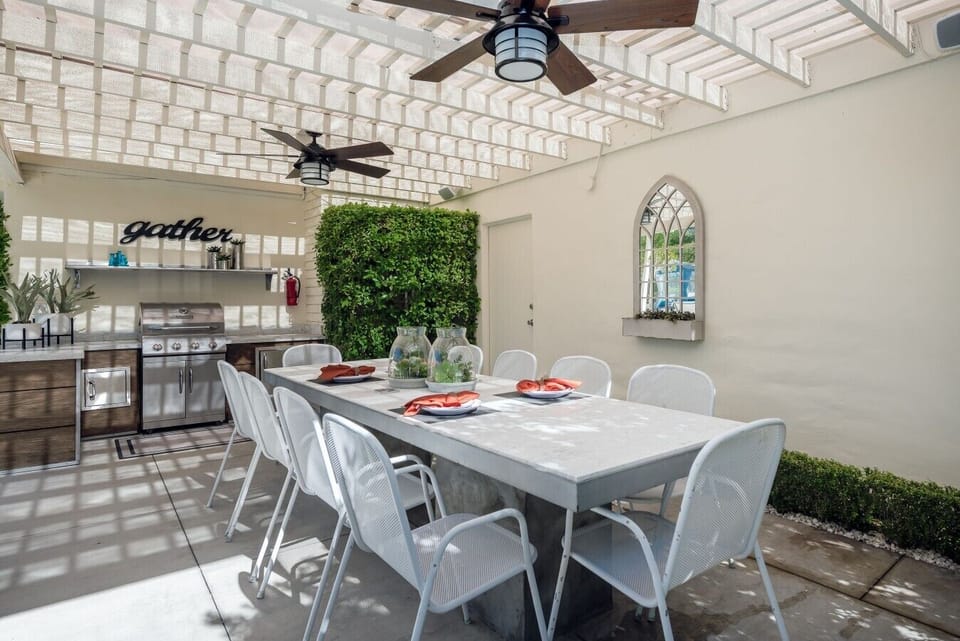Covered Outdoor Kitchen and Dining Area With Two Ceiling Fans & Gas Grill