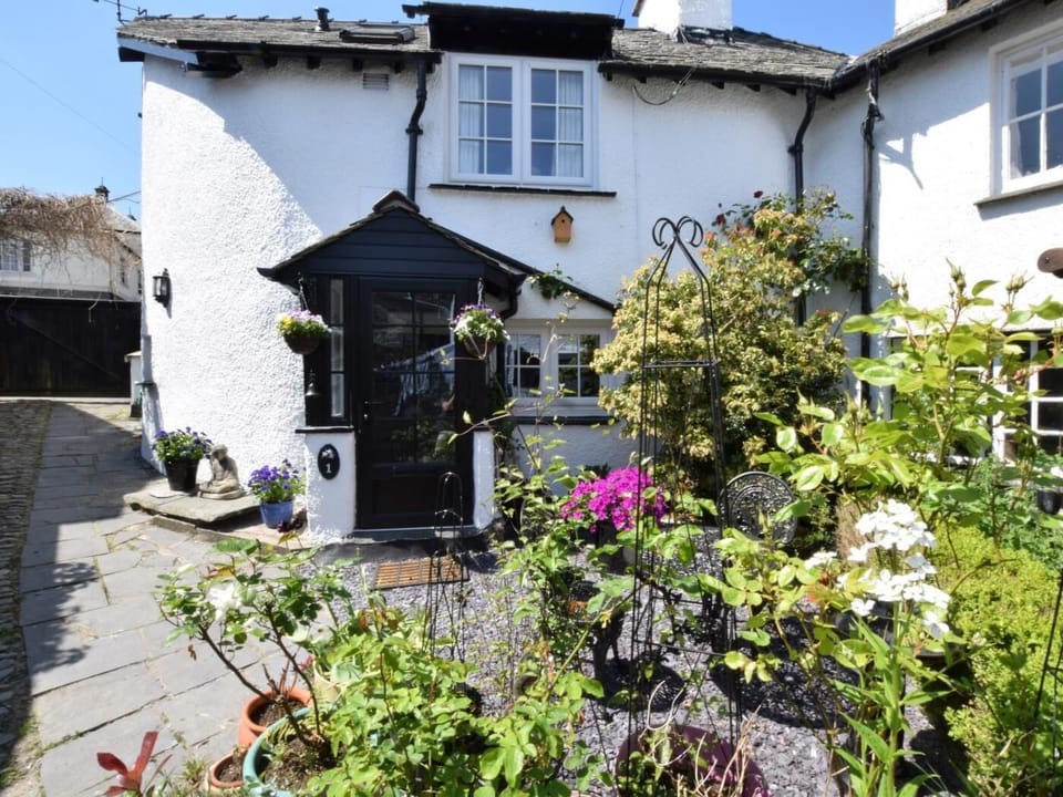 Front of the property with outside seating area 
