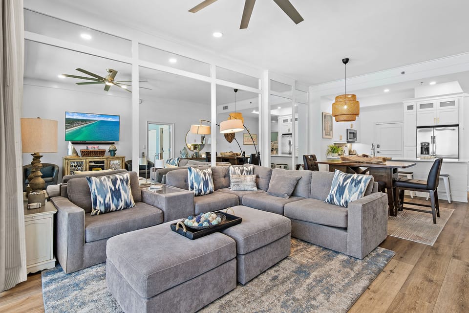 Living Room with High Ceiling and Mirrored walls provide a comfortable airy feeling to the room