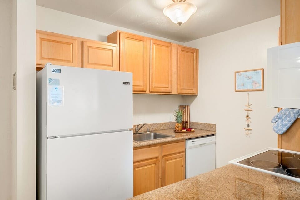 Full kitchen with appliances, cookware, and island-inspired touches.