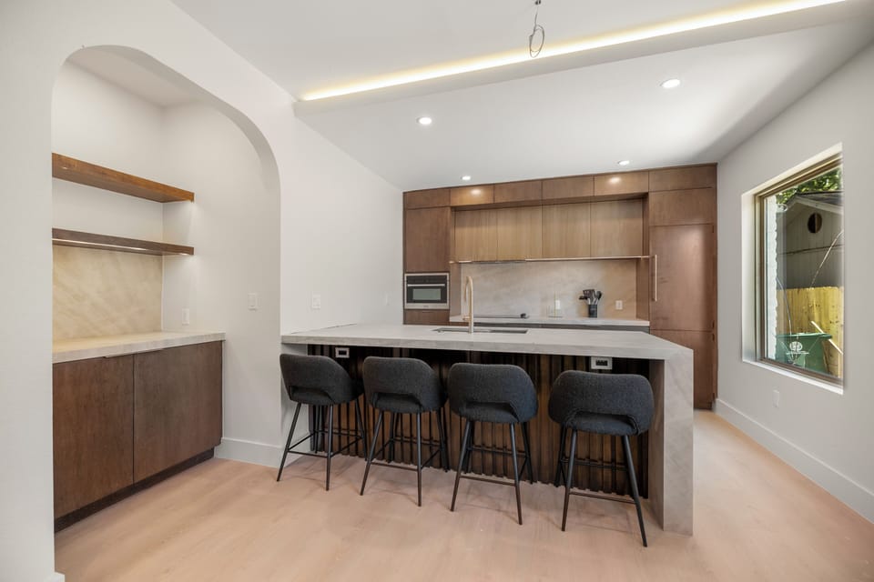 Modern designer kitchen with waterfall island and seating for four