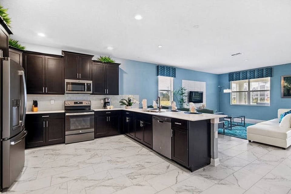 Corner view of the sleek, modern kitchen showing stainless steel appliances.