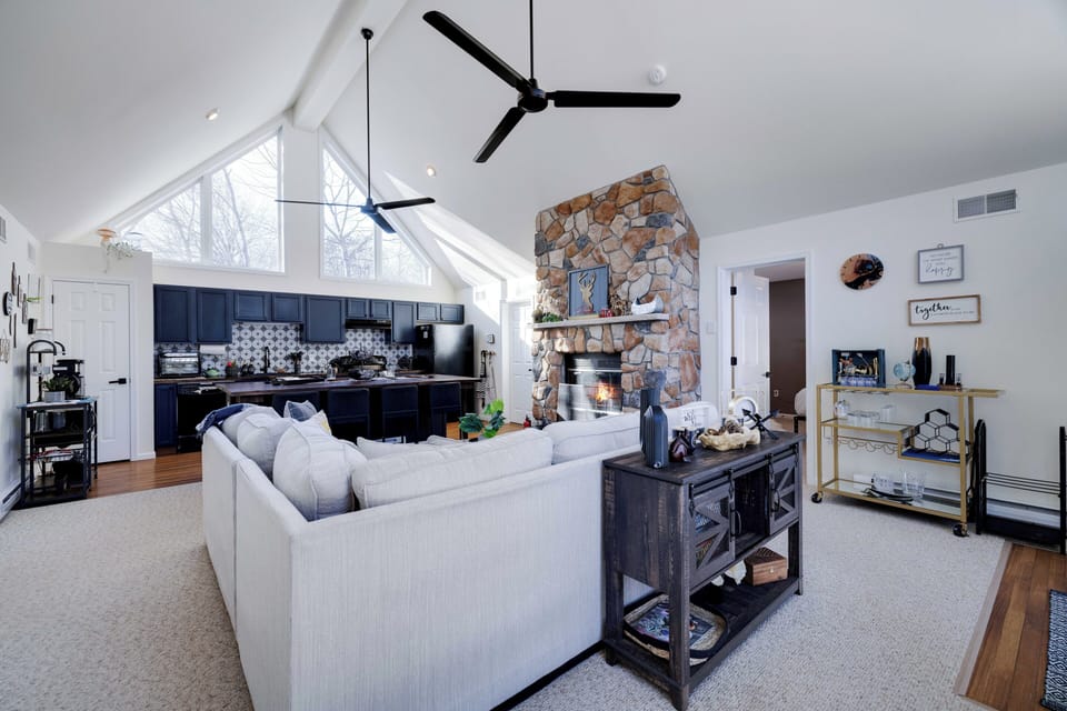 Open-concept living with fireplace, comfortable seating, and modern finishes.