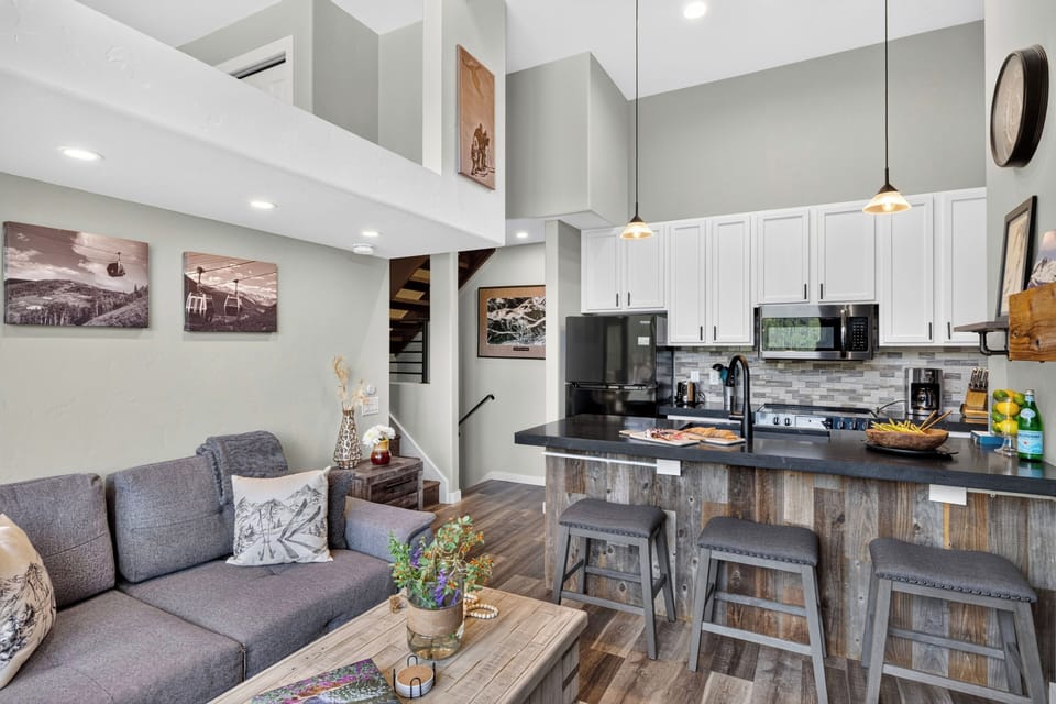 Warm and inviting great room looking from the comfortable lounge space toward the gourmet kitchen.