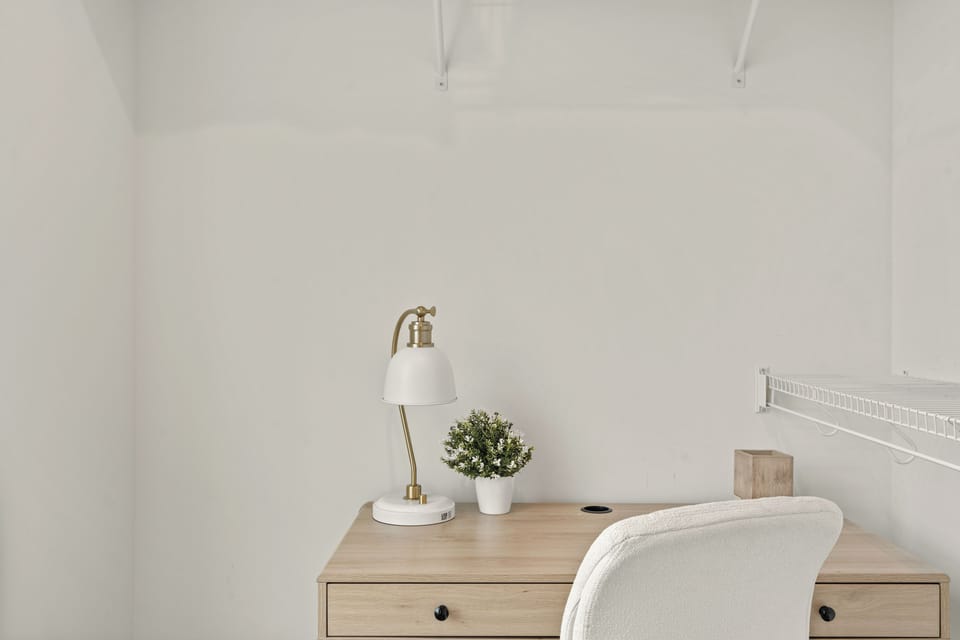 The primary bedroom features a king bed, TV, desk and an ensuite bathroom.