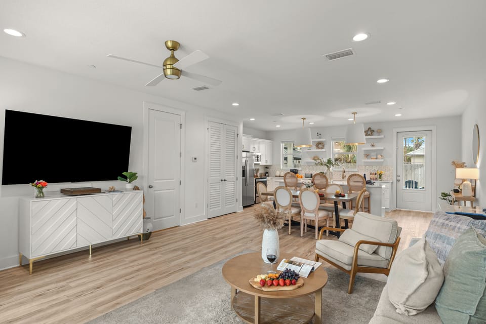 Bright open-concept living, dining, and kitchen space with coastal style and plenty of room to gather.