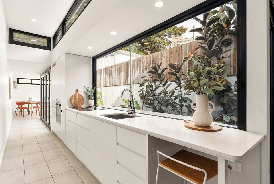 Prepare meals in the streamlined kitchen while enjoying an outlook over the courtyard garden.