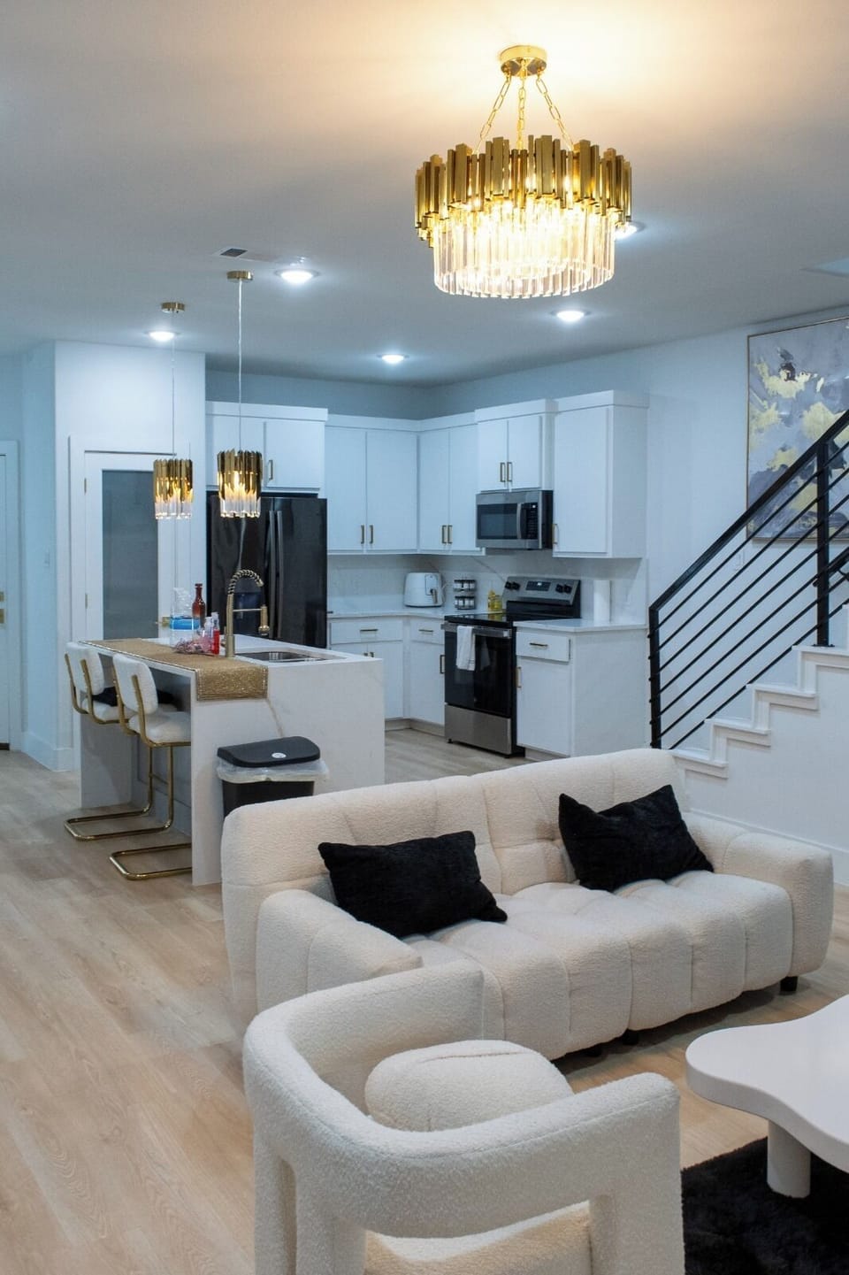 Stylish open-concept living with chic lighting and a modern chef’s kitchen