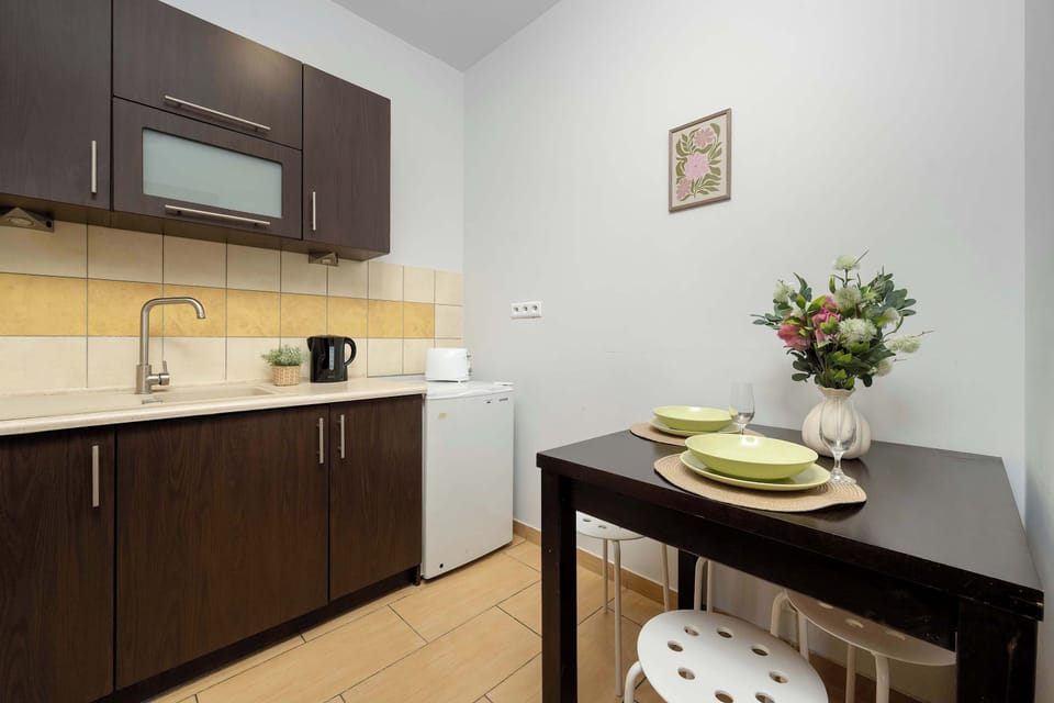 Fully equipped kitchen with built-in appliances and a dining area.