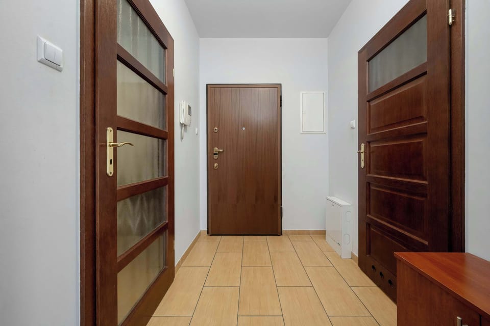 Spacious entrance hallway with a bench, coat hooks, and access to the apartment rooms.