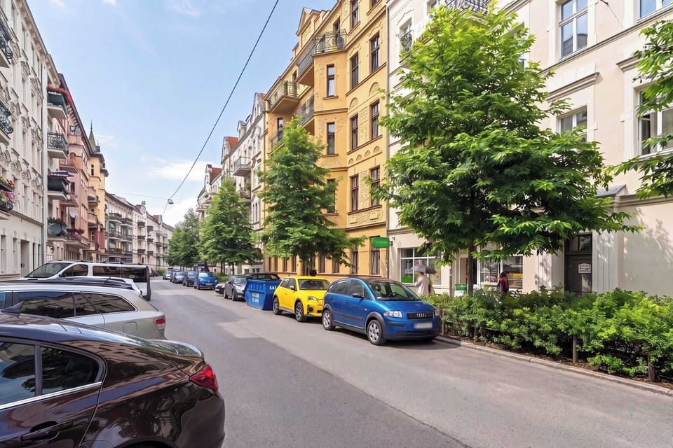 Tree-lined street surrounding the apartment, combining peaceful surroundings with a central location.