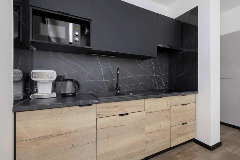 The sleek design of the kitchenette blending seamlessly with the living area.