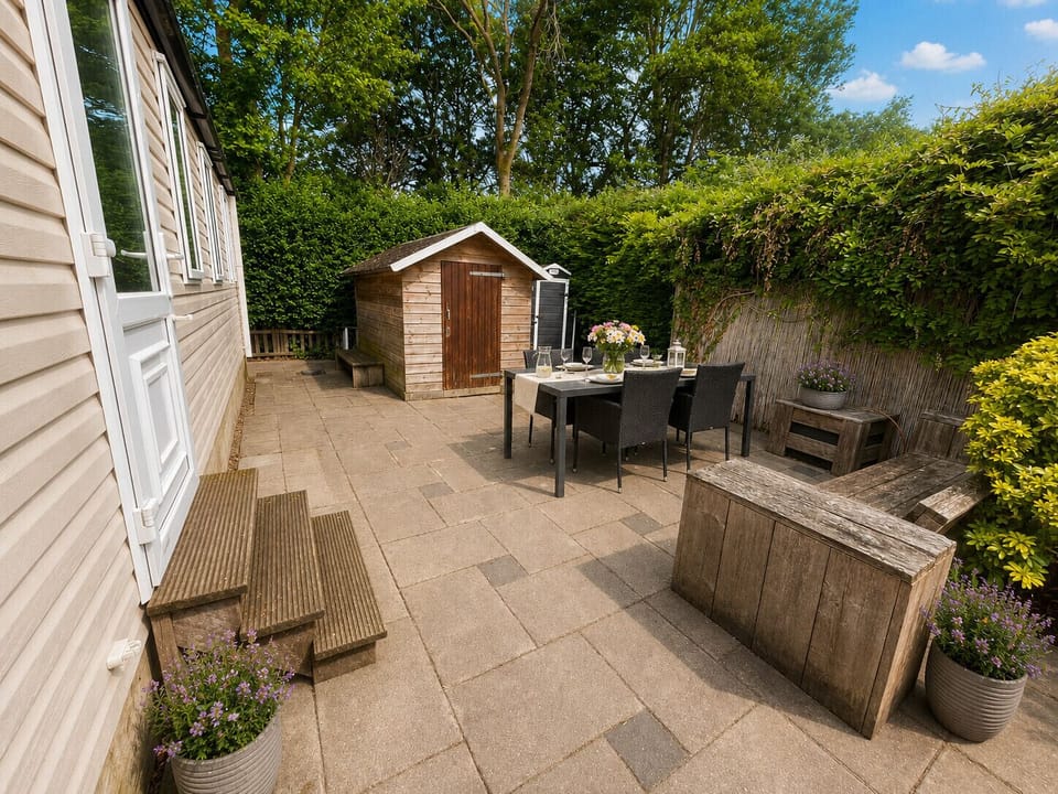 Spacious garden with cozy seating area and parasol