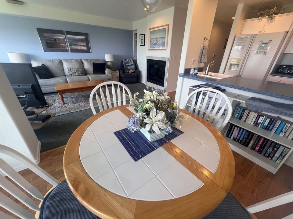 Looking down from above, discover the cozy circular dining nook where you'll gather for meals surrounded by coastal charm and thoughtful details throughout your stay.