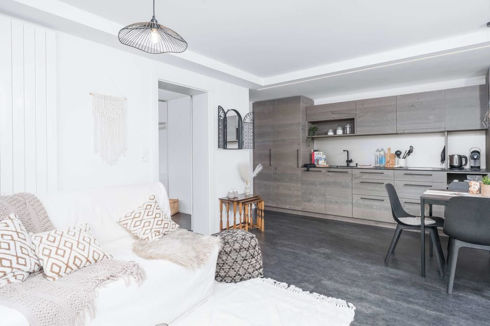 Bright open-plan living area combining the lounge, dining space, and kitchen.
