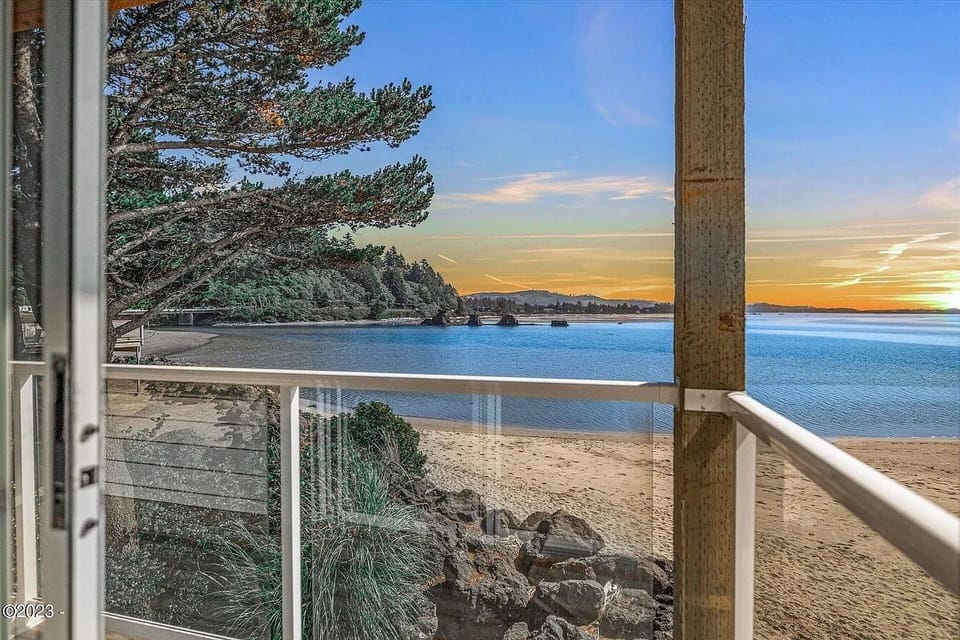 Stunning beachfront location with direct beach access, pine-lined shores, and mesmerizing sunset views over the bay—an idyllic coastal retreat.