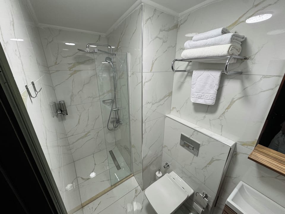 Economy Double Room | Bathroom | Shower, hair dryer, slippers, towels