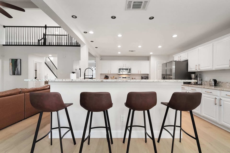 Spacious open kitchen with breakfast bar seating—perfect for casual meals and morning coffee.