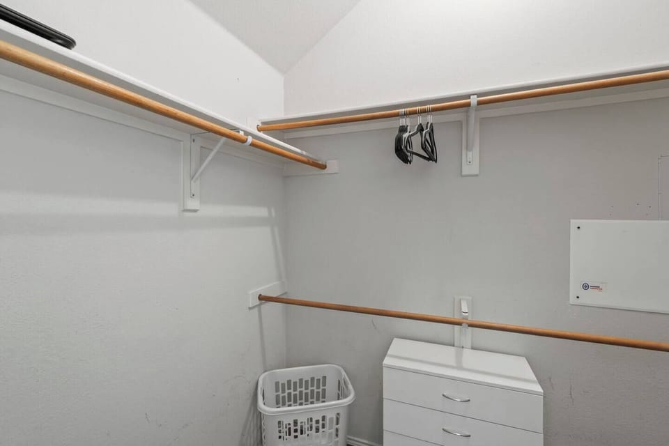 Spacious walk-in closet with ample hanging space and storage.