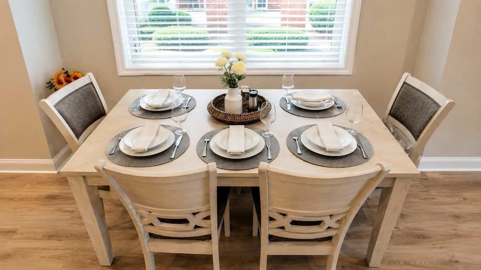 Bright and welcoming dining area offering comfortable seating for six and easy access to the kitchen.