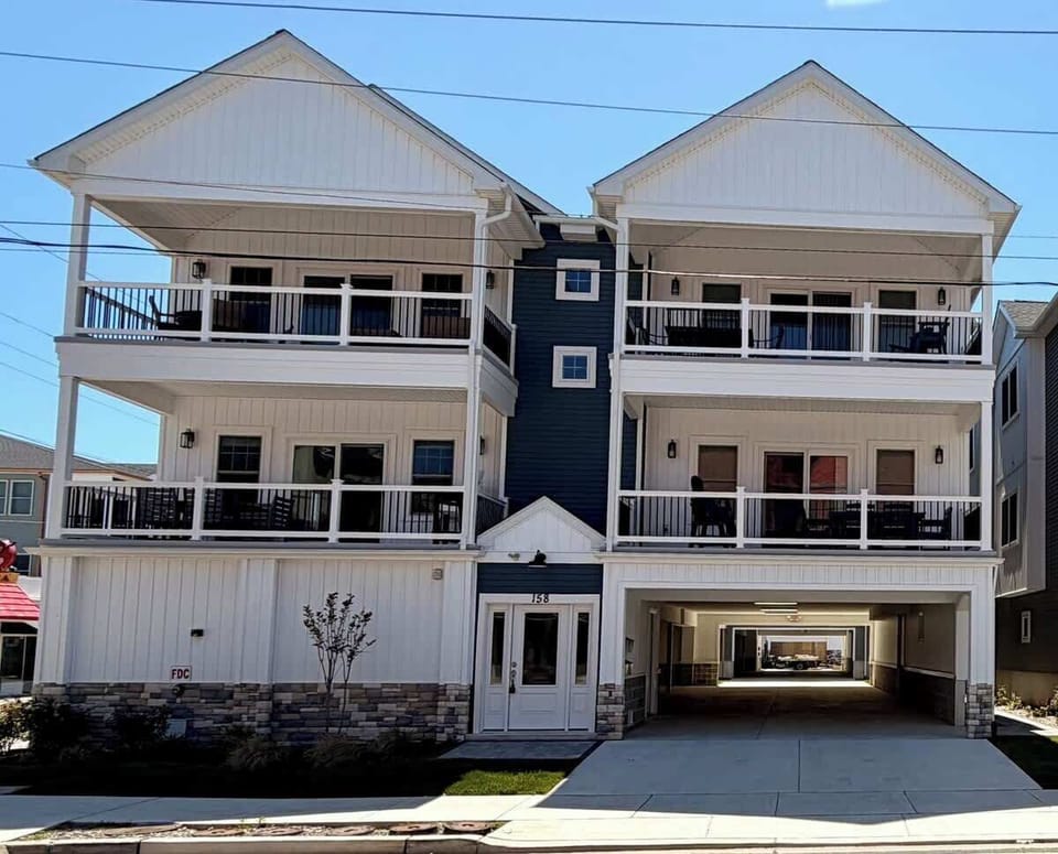 
Contemporary beachside retreat with private outdoor living spaces, covered parking, and easy access to the beach, boardwalk, restaurants, and shops.
