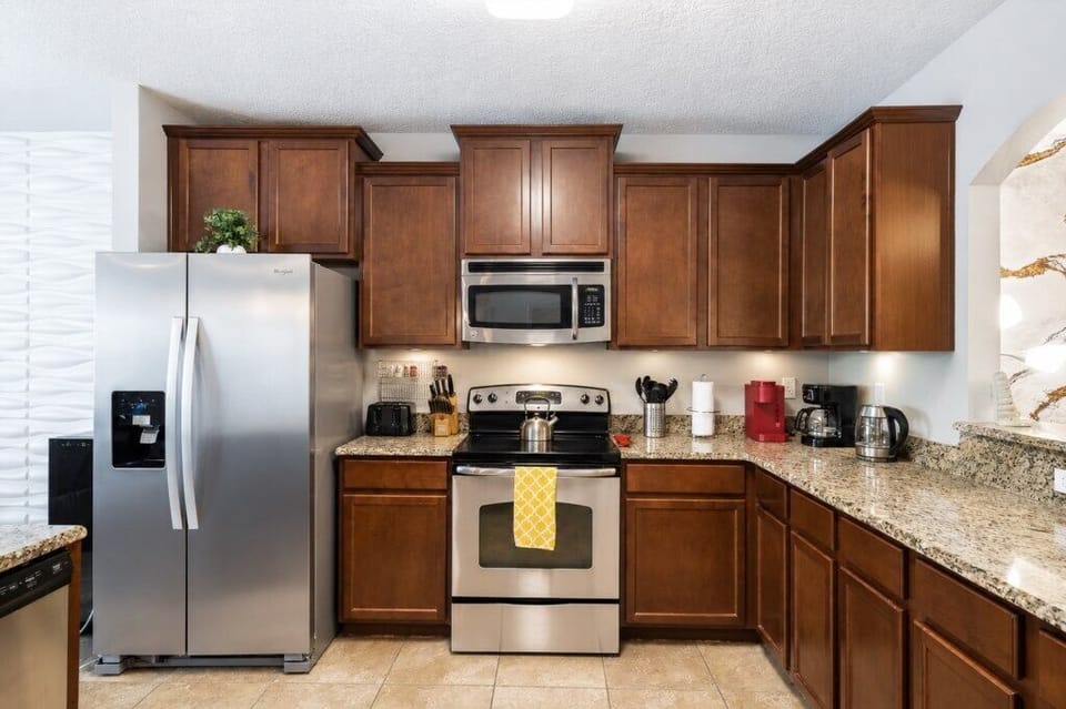 Modern kitchen with stainless steel appliances and granite countertops for gourmet cooking.