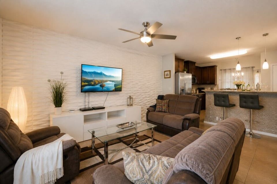 Modern living room with plush seating and a flat-screen TV, perfect for relaxing evenings.