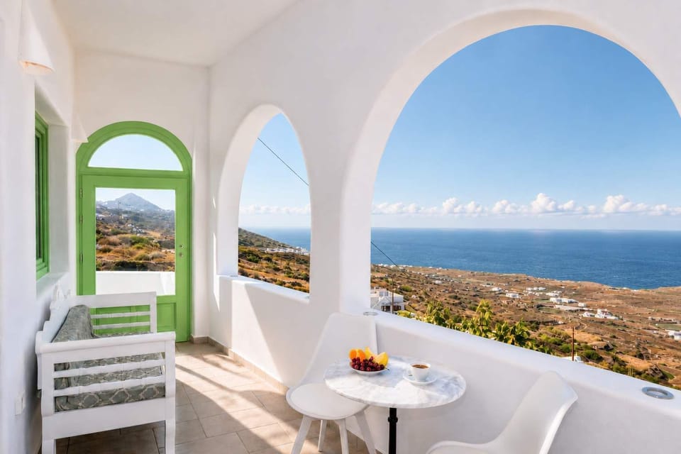 Beautiful terrace seating with arches, sea views, and a calm Santorini atmosphere.