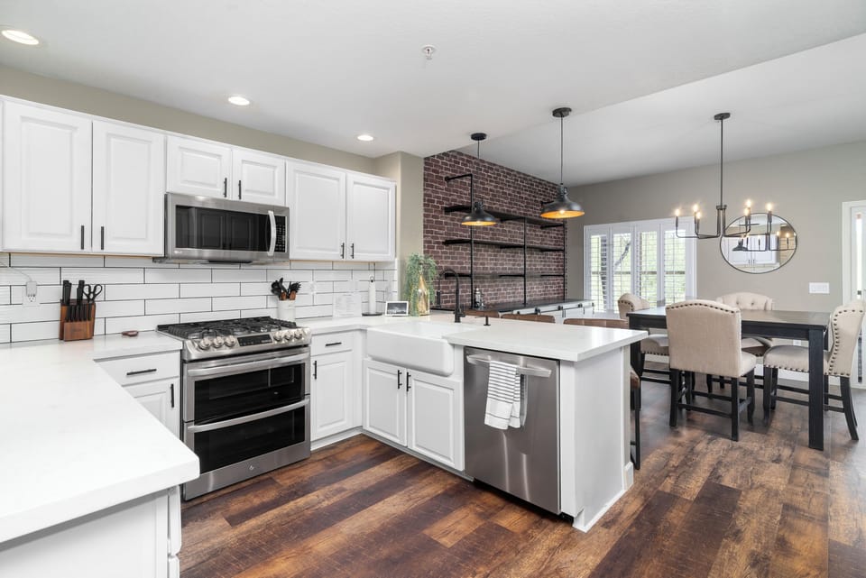 Fully stocked kitchen with premium appliances including gas cooktop, dual ovens, dual ice makers, and wine fridge too. 