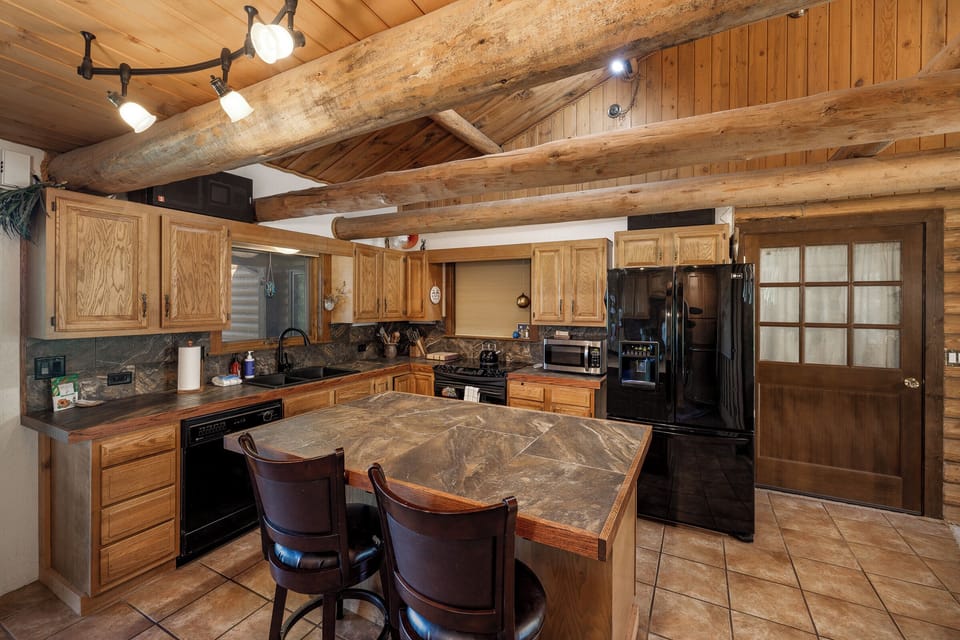 Rustic kitchen with log beams | Upper Level