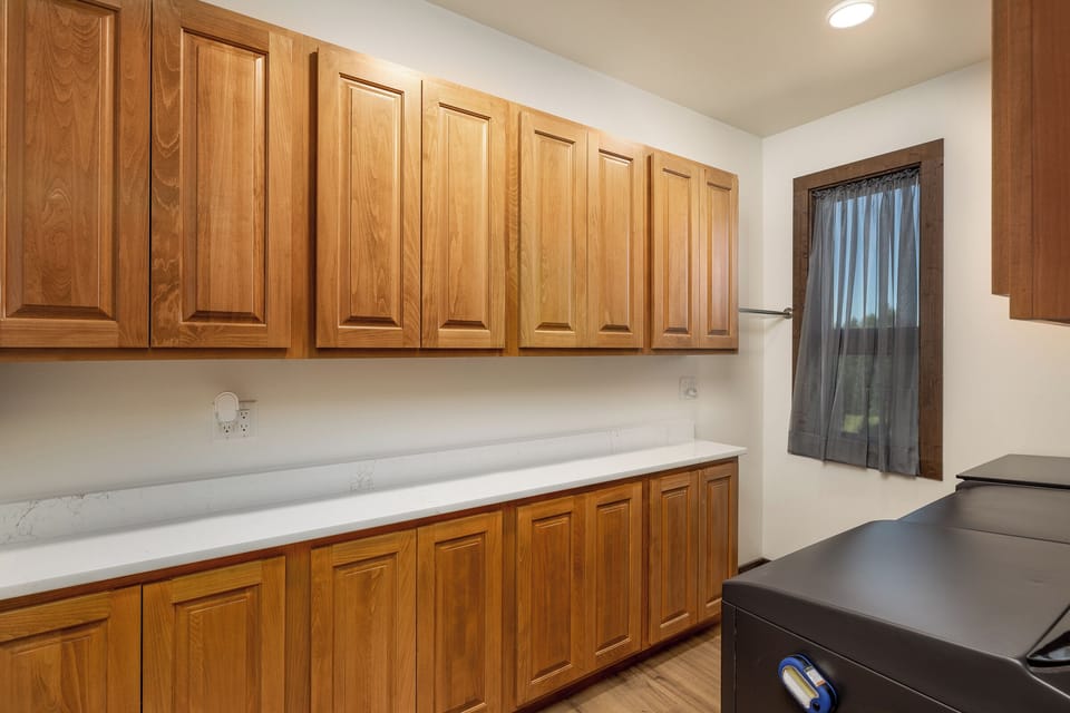 Large laundry room with washer and 
2 dyers | Upper Level
