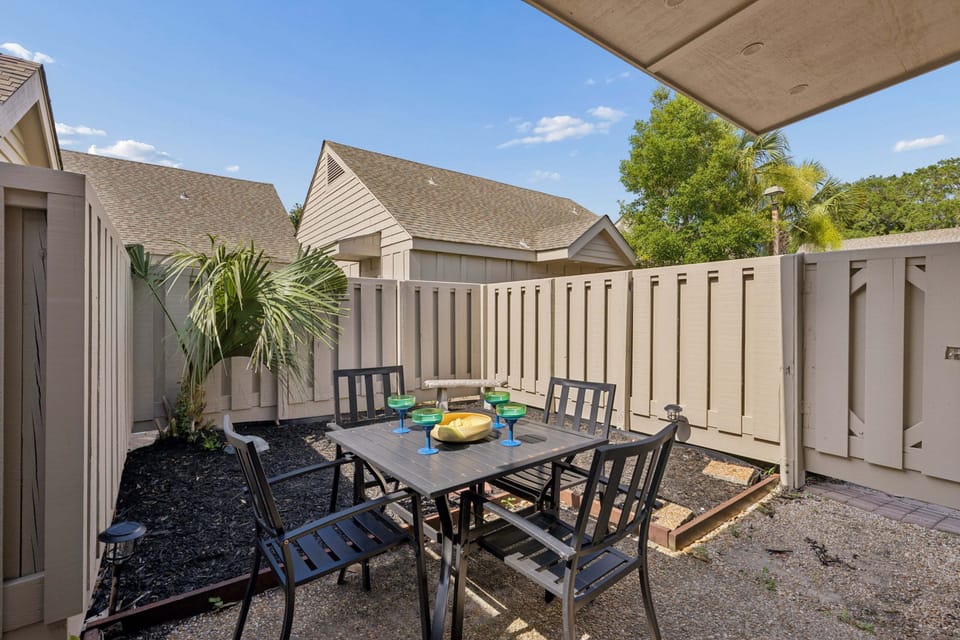 Step outside to the private fenced patio and you'll find a shaded outdoor dining table for four