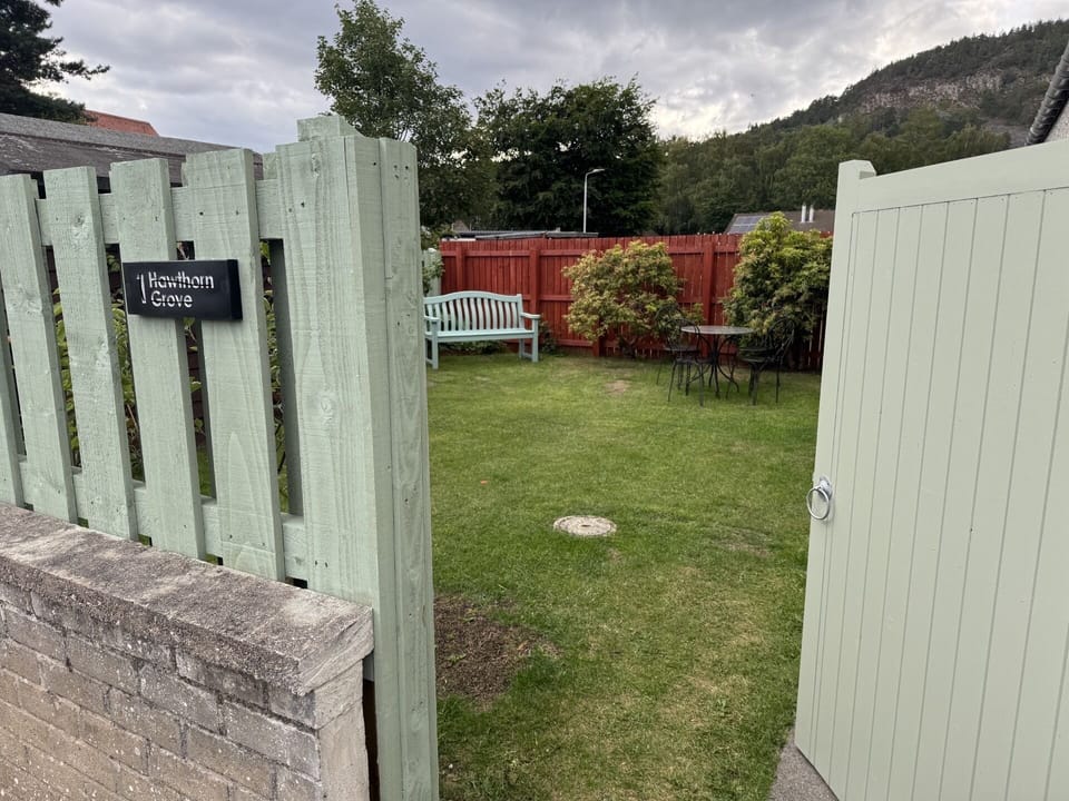 Rear garden gate to enclosed garden and entry.
