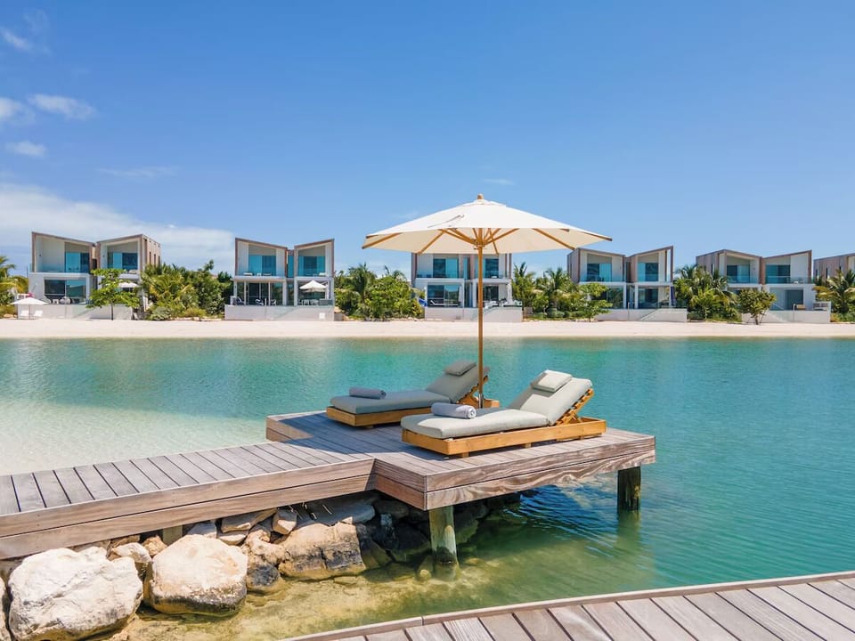 Unwind on your private dock daybed above crystal lagoon.