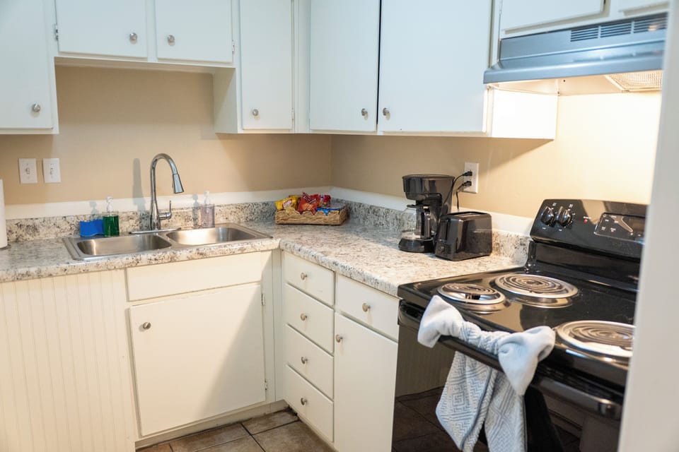 Bright, tidy kitchen with coffee station and full cooking essentials