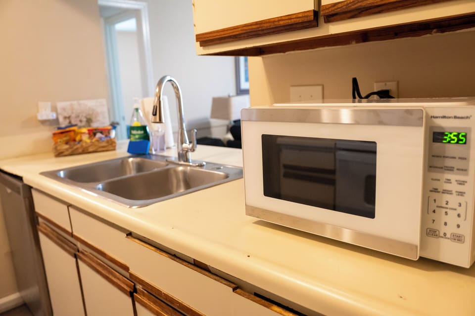Well-equipped kitchen with microwave, double sink, and prep space