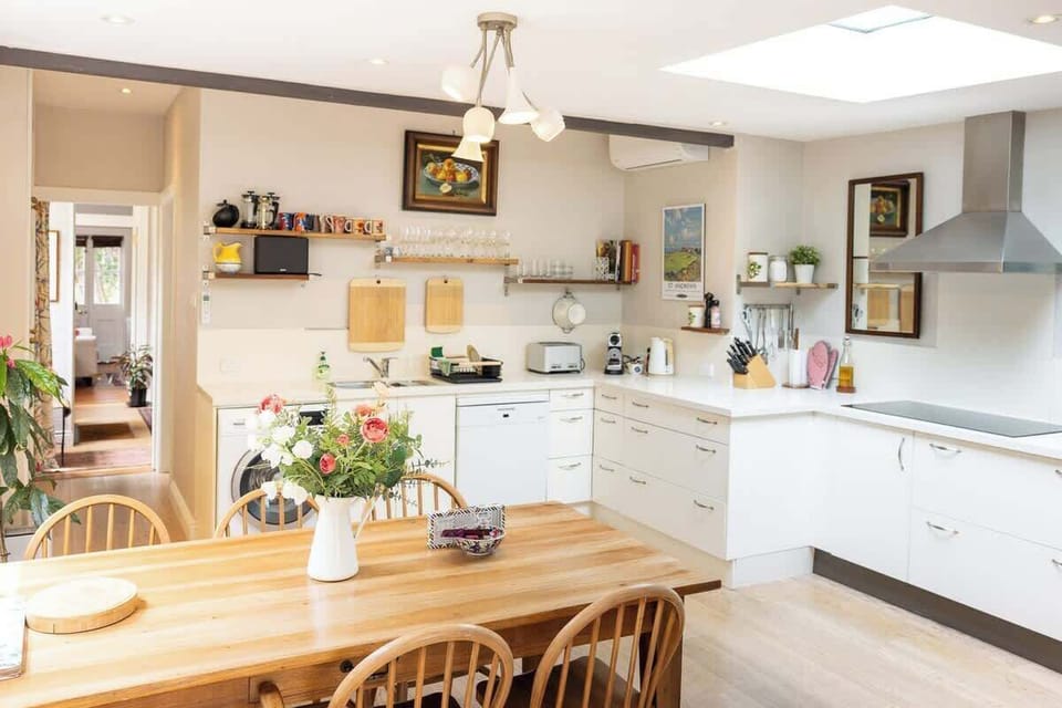 Large kitchen sunlit with windows and skylight