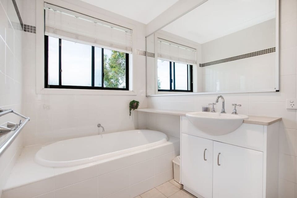 Main family bathroom with a full-size bathtub and separate shower.