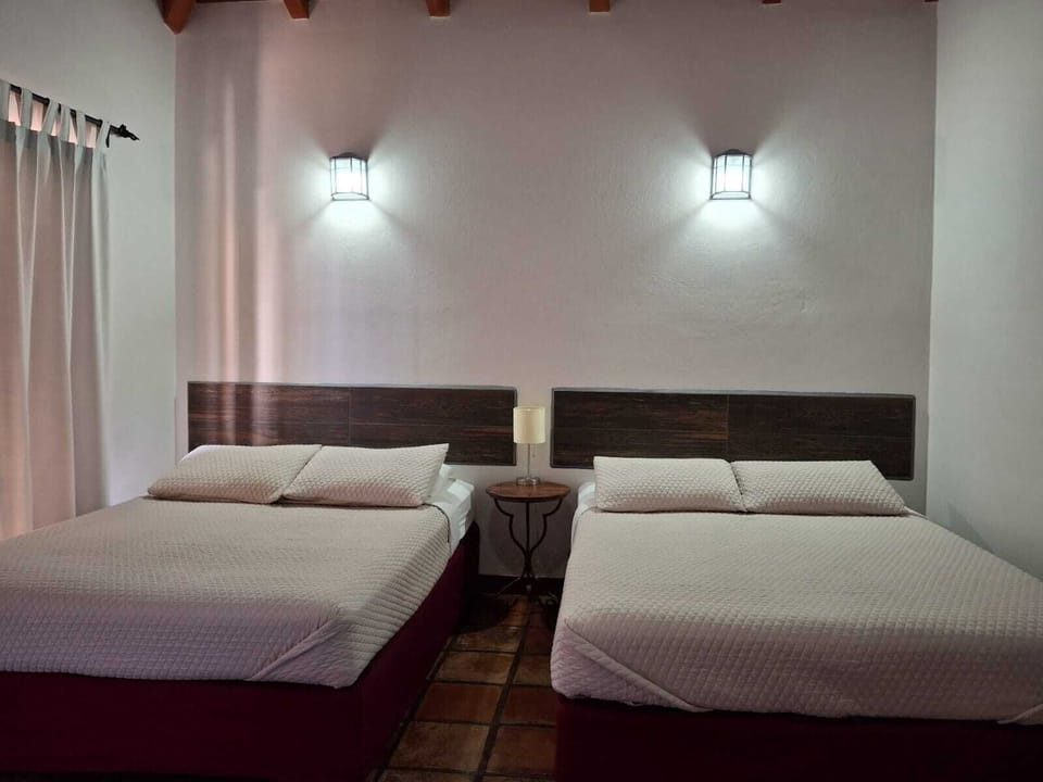 Deluxe Quadruple Room, 1 Bedroom, Pool View | Minibar, in-room safe, desk, blackout drapes