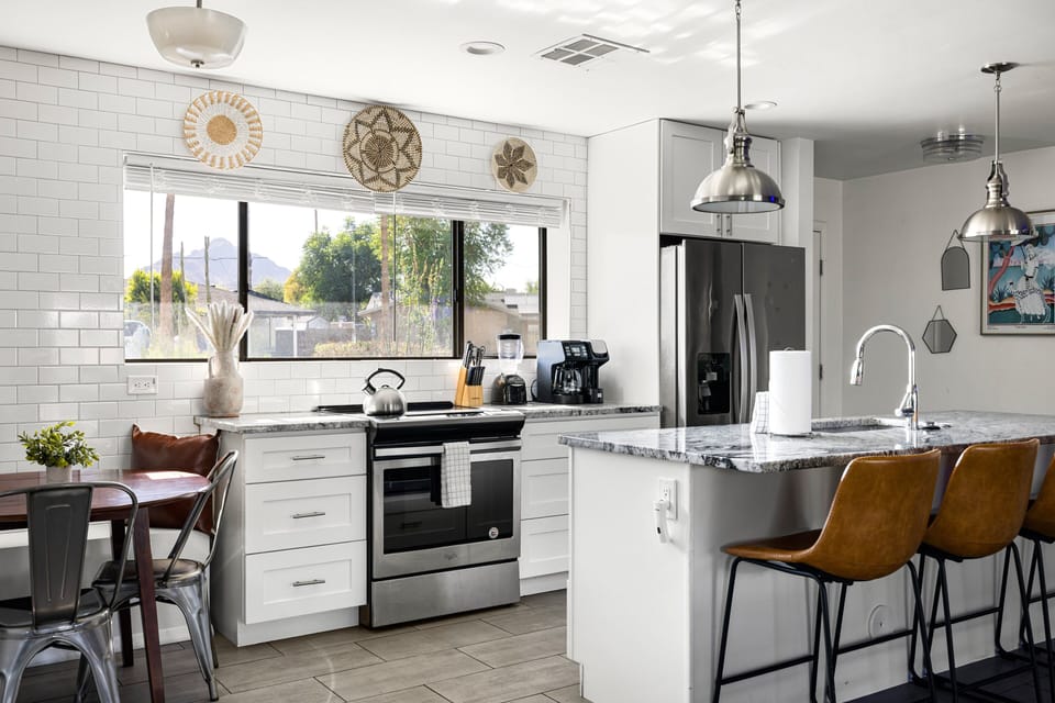 Bright and modern, the fully equipped kitchen offers stainless steel appliances, bar seating, and everything needed to prepare meals with ease.