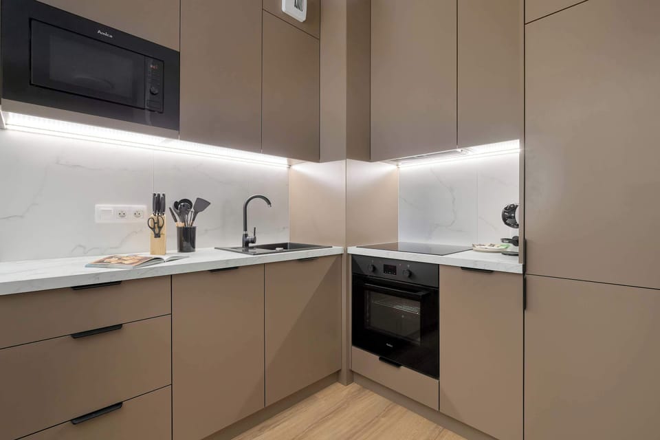 The sleek design of the kitchenette blending seamlessly with the living area.