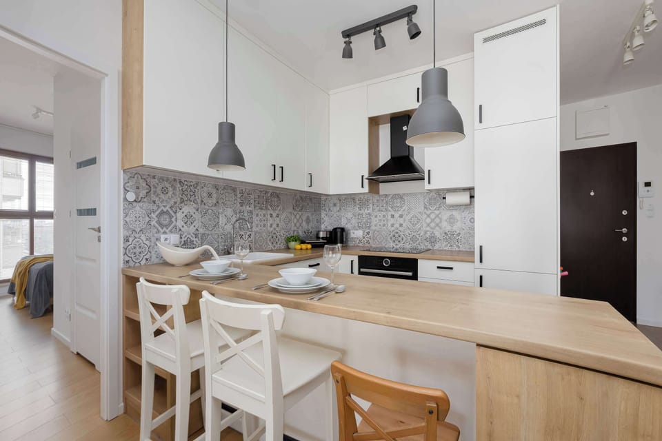 Open-plan kitchenette connected to the dining and living area, creating a bright and functional living space.