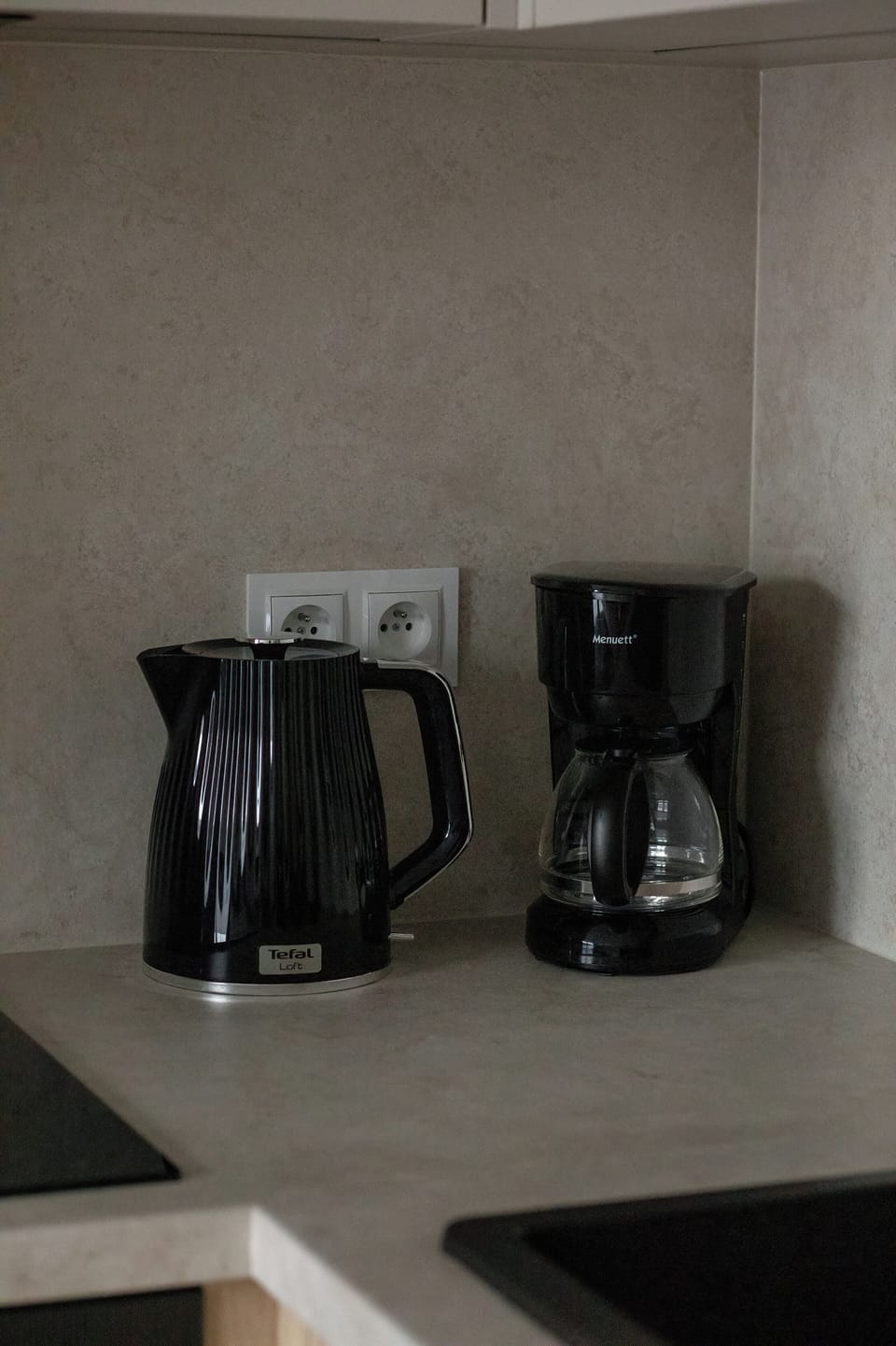 Coffee station with an electric kettle and coffee machine.