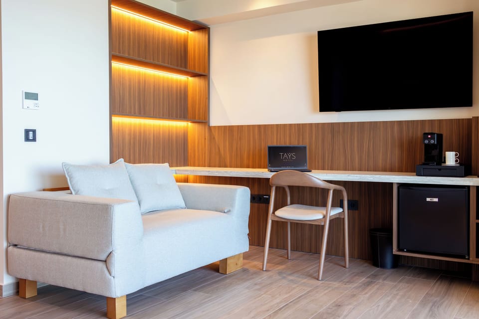 Junior Suite, Balcony, Sea View | Minibar, in-room safe, desk, blackout drapes