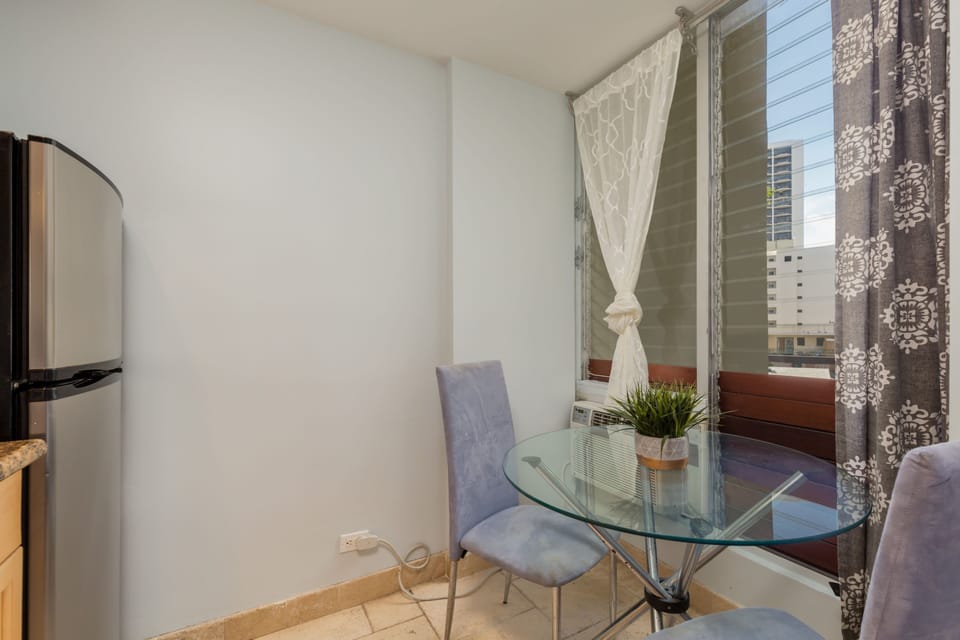 Relax at your private glass table for intimate meals or morning coffee while you take in the urban views through your window. The cozy seating makes it perfect for quiet moments.