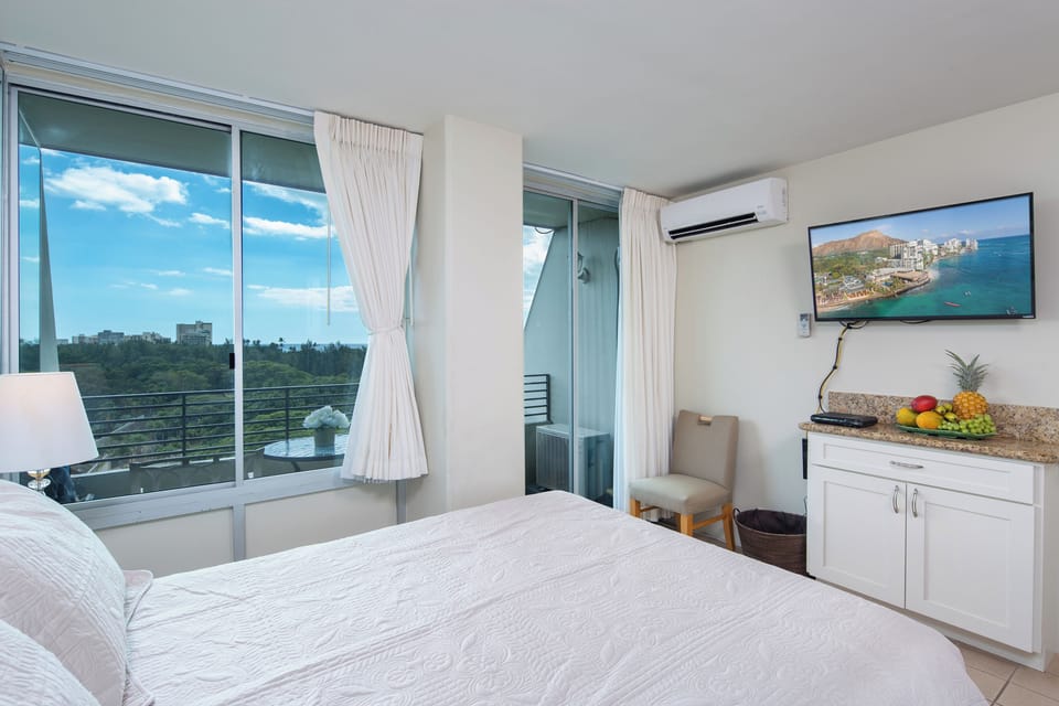 Wake up to ocean views framed by floor-to-ceiling windows. Your private balcony invites morning coffee as gentle breezes cool the air. Every detail, from plush bedding to fresh tropical fruit, welcomes you home.