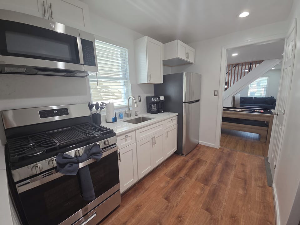 Bright modern kitchen with stainless appliances and easy open layout