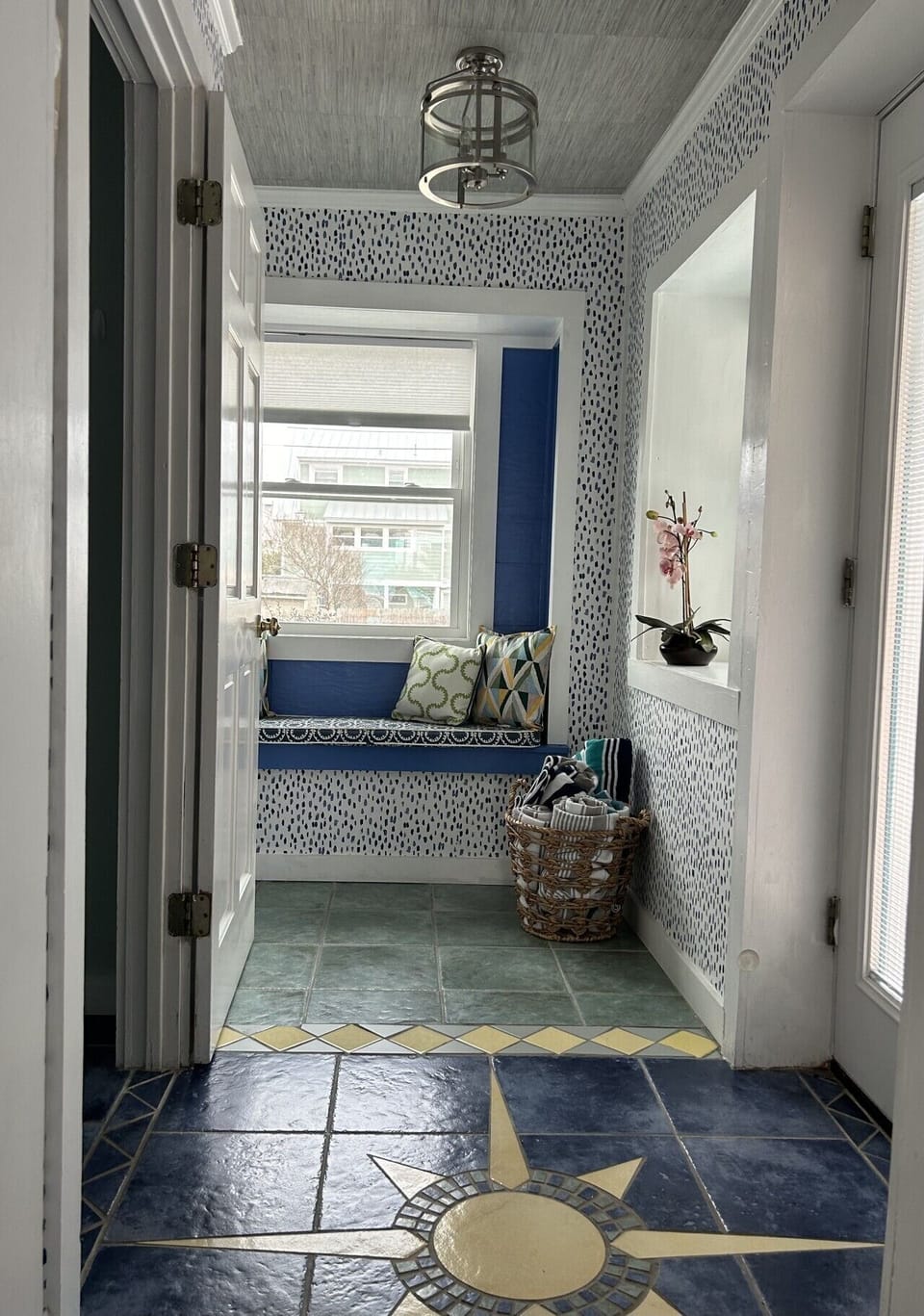 Charming sitting nook featuring built-in bench seating, coastal accents, and natural light