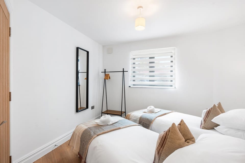 Bright and inviting bedroom with soft bedding and contemporary decor inspired by Brighton's coastal charm
