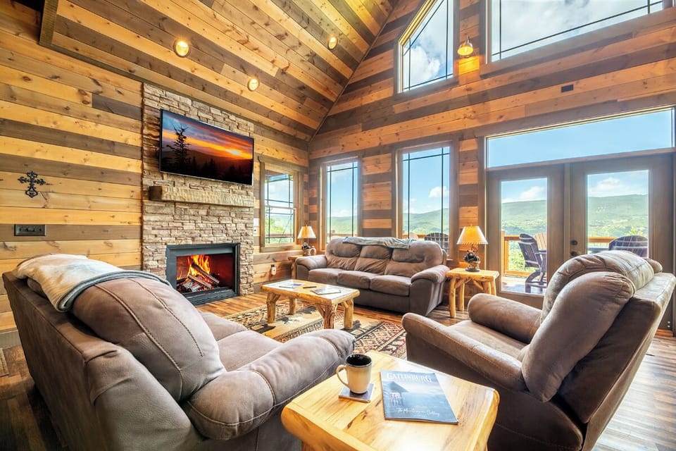 Sink into plush seating by the crackling fireplace and let your gaze drift through soaring windows to the mountain views beyond. This warm, inviting space is your retreat after a day of adventure.